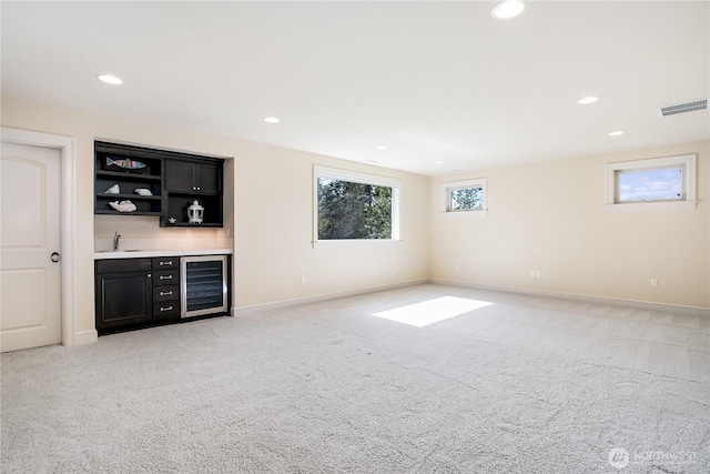 1220 Madrona Beach Rd NW, Olympia, WA 98502 - bar with wine cooler, light colored carpet, a sink, and visible vents