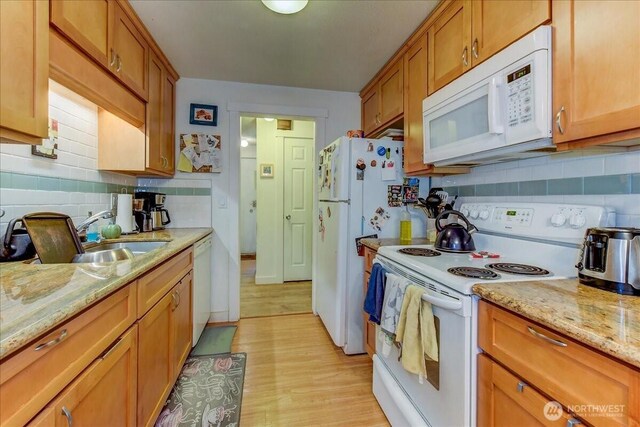 4509 Eastern Ave N Unit 1-3, Seattle, WA 98103 - kitchen featuring white appliances, tasteful backsplash, brown cabinets, and a sink