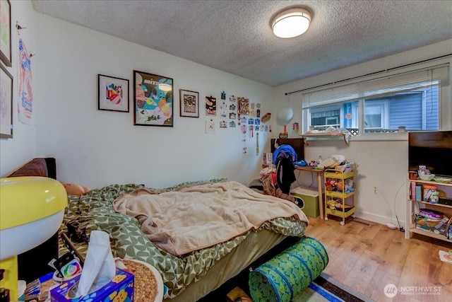 4509 Eastern Ave N Unit 1-3, Seattle, WA 98103 - bedroom with wood finished floors and a textured ceiling