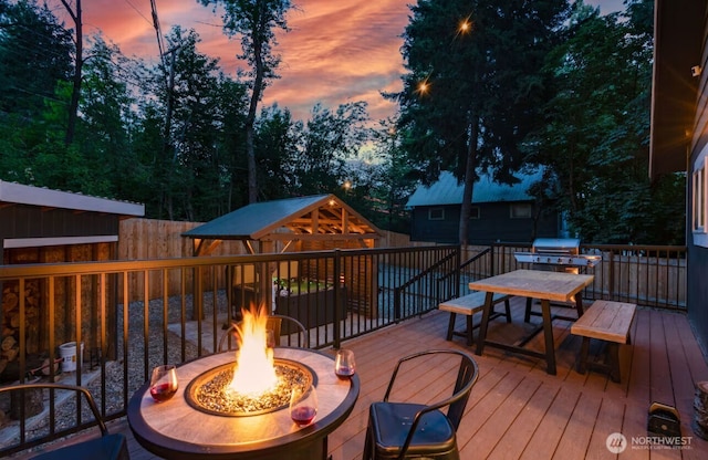 417 W 2nd St, Cle Elum, WA 98922 - wooden deck featuring an outdoor fire pit, fence, and outdoor dining space
