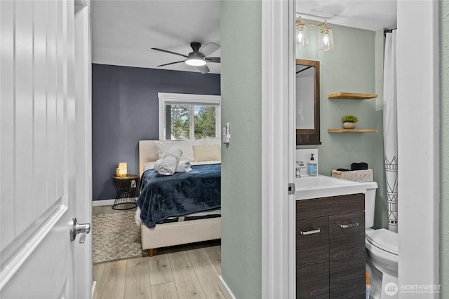 417 W 2nd St, Cle Elum, WA 98922 - bedroom featuring a sink, baseboards, light wood-style floors, and ceiling fan