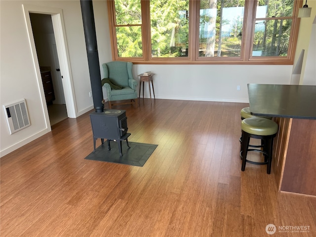 186 S Ridge Rd, Decatur Island, WA 98221 - living area with a wood stove, visible vents, baseboards, and wood finished floors