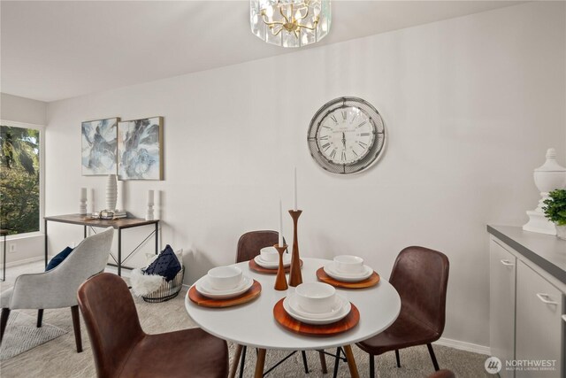 6201 Lake Washington Blvd NE Unit 206, Kirkland, WA 98033 - dining area with a notable chandelier, carpet, and baseboards