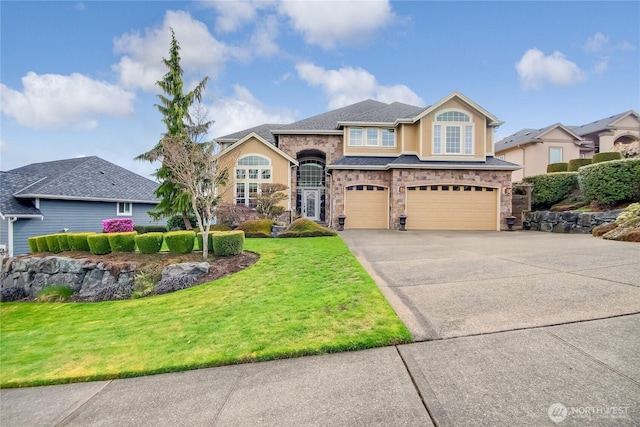view of front of home featuring stone siding, a garage, stucco siding, a front yard, and concrete driveway