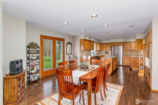 dining space with french doors, recessed lighting, and dark wood finished floors