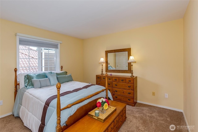 bedroom featuring light colored carpet and baseboards