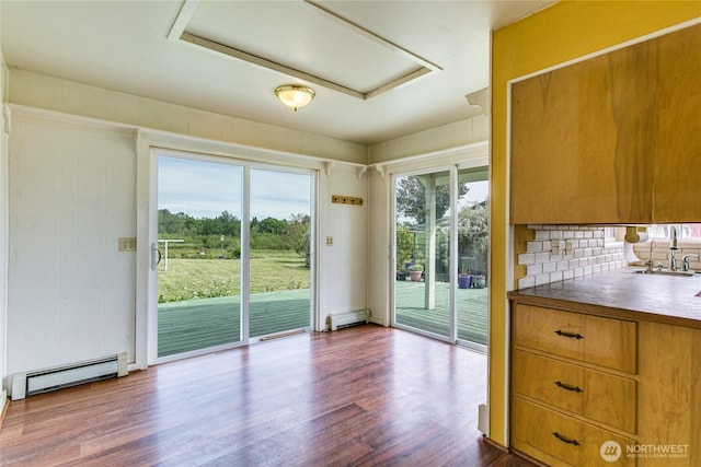5296 Olson Rd, Ferndale, WA 98248 - unfurnished dining area featuring baseboard heating, a sink, dark wood-type flooring, and a baseboard heating unit