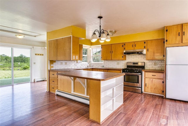 5296 Olson Rd, Ferndale, WA 98248 - kitchen featuring freestanding refrigerator, stainless steel gas range oven, under cabinet range hood, baseboard heating, and open shelves