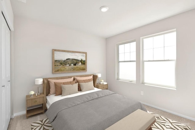 bedroom with light carpet, baseboards, and a closet