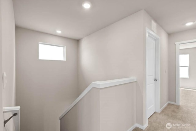 hallway with recessed lighting, an upstairs landing, carpet, and a healthy amount of sunlight