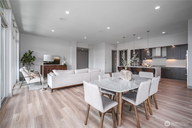 dining area featuring light wood finished floors and recessed lighting