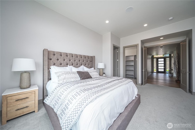 bedroom featuring recessed lighting, light carpet, and baseboards