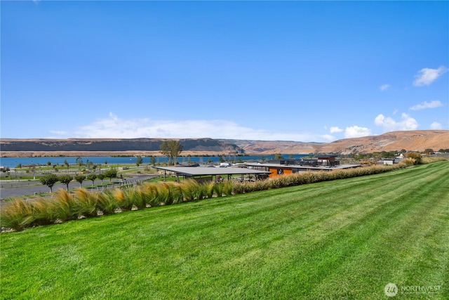 exterior space with a water and mountain view