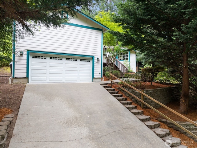 garage featuring concrete driveway