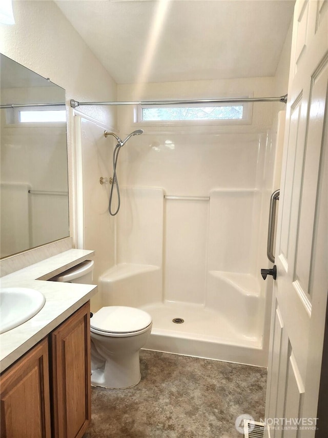 bathroom with toilet, walk in shower, and vanity
