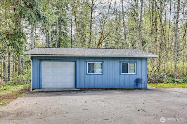 garage with a view of trees