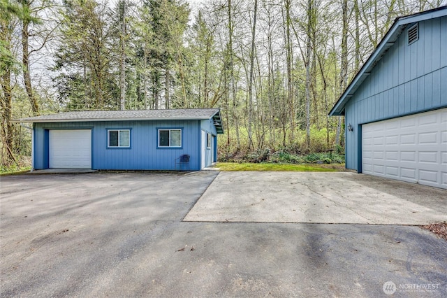 garage featuring a wooded view