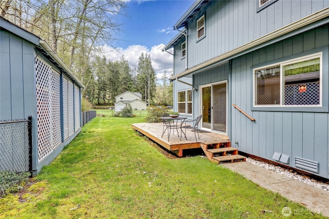 view of yard featuring fence and a deck