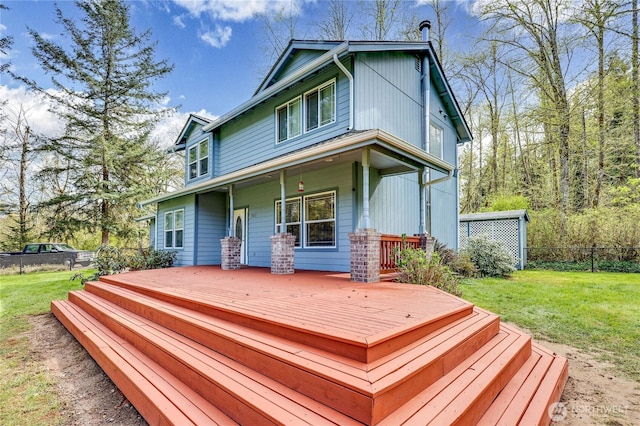 deck featuring a porch, fence, and a lawn