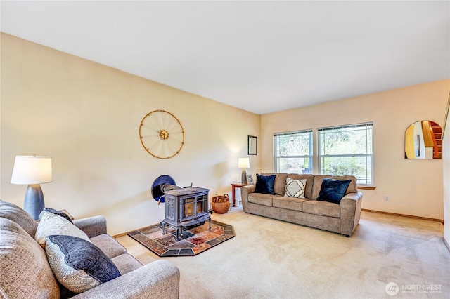 living room featuring a wood stove, carpet flooring, and baseboards