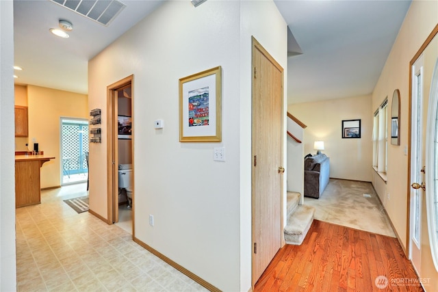 corridor featuring visible vents, recessed lighting, light wood-style floors, and stairs
