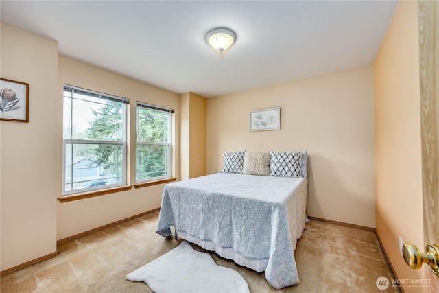 carpeted bedroom with baseboards