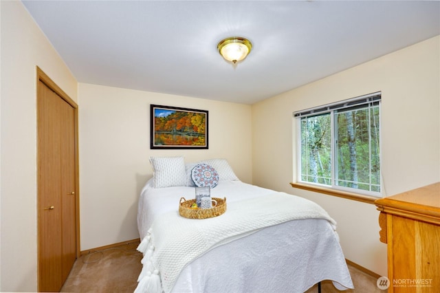 bedroom with carpet flooring and baseboards