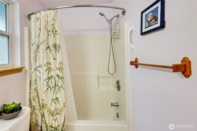 bathroom with toilet and shower / tub combo with curtain