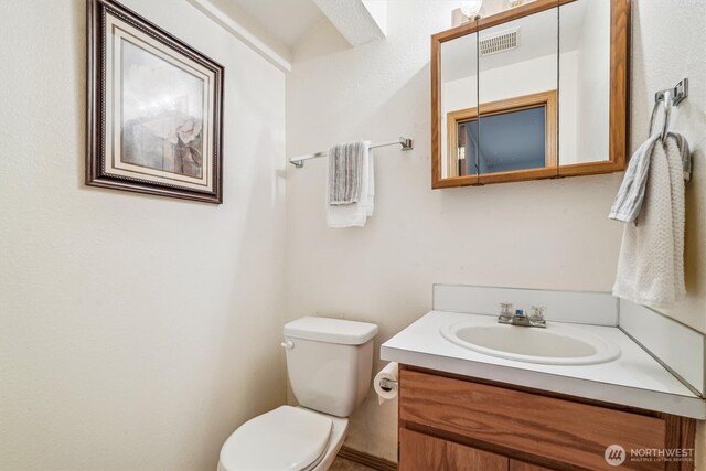 12802 Silver Dr, Anderson Island, WA 98303 - half bathroom with visible vents, toilet, and vanity