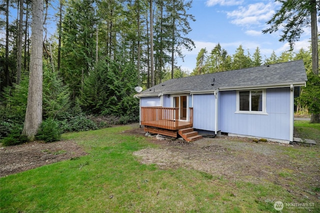 12802 Silver Dr, Anderson Island, WA 98303 - back of house with roof with shingles, a yard, and a wooden deck