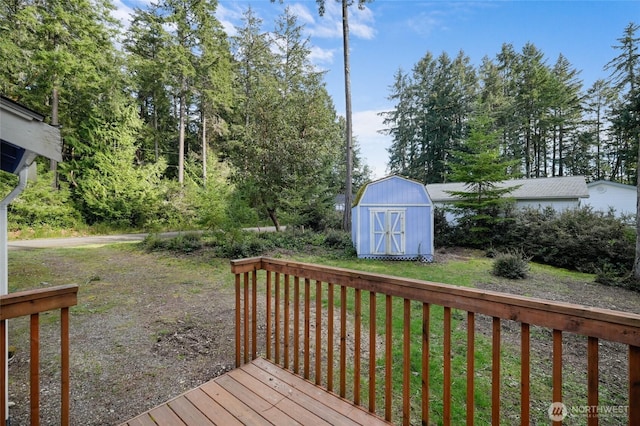12802 Silver Dr, Anderson Island, WA 98303 - wooden terrace with a storage shed, an outbuilding, and a lawn