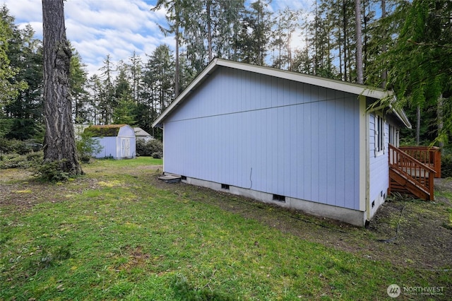 12802 Silver Dr, Anderson Island, WA 98303 - view of side of property featuring a storage shed, an outbuilding, and a yard
