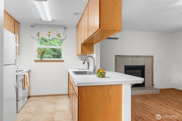 12802 Silver Dr, Anderson Island, WA 98303 - kitchen with a wall mounted air conditioner, a sink, light countertops, white appliances, and a fireplace
