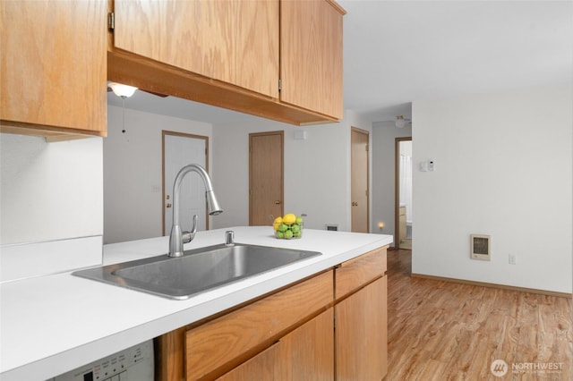 12802 Silver Dr, Anderson Island, WA 98303 - kitchen with light countertops, a sink, white dishwasher, and light wood-style flooring