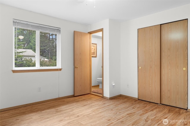 12802 Silver Dr, Anderson Island, WA 98303 - unfurnished bedroom featuring a closet, baseboards, and light wood-style floors