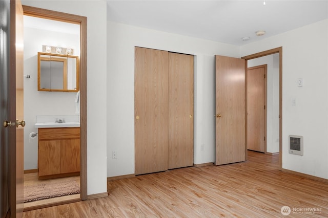 12802 Silver Dr, Anderson Island, WA 98303 - unfurnished bedroom with a closet, light wood finished floors, baseboards, and heating unit