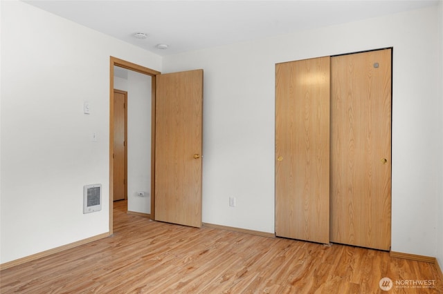 12802 Silver Dr, Anderson Island, WA 98303 - unfurnished bedroom featuring a closet, light wood finished floors, baseboards, and visible vents
