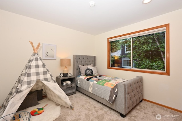 bedroom with light carpet and baseboards