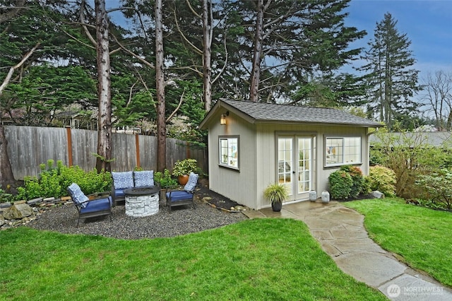 view of outdoor structure with an outbuilding and fence