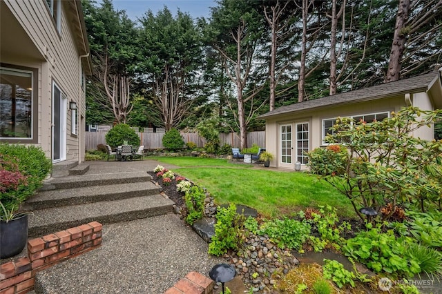 view of yard featuring a patio and an outbuilding