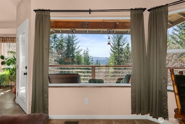 interior space with a mountain view, visible vents, and tile patterned flooring