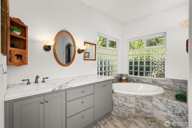 full bathroom featuring vanity and a garden tub