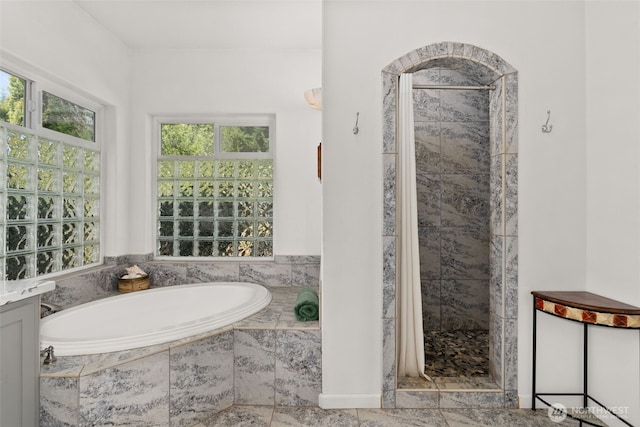 full bathroom with a bath and a shower stall