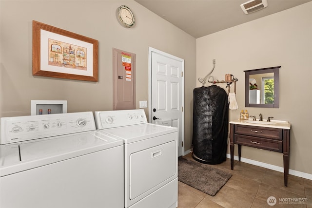 laundry area featuring light tile patterned floors, baseboards, a sink, visible vents, and washer and dryer
