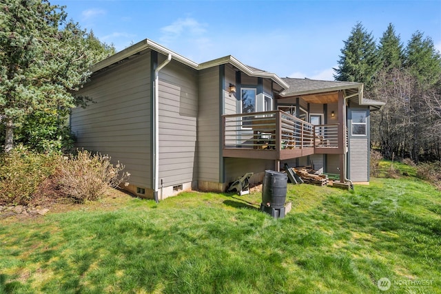 rear view of house with crawl space and a yard