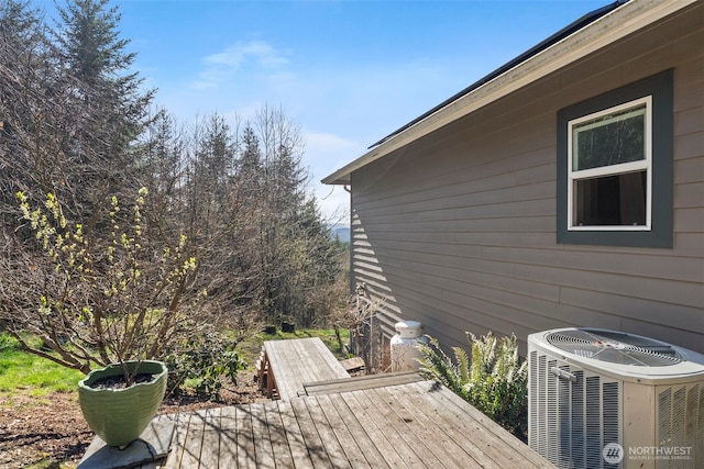 wooden deck featuring central AC unit