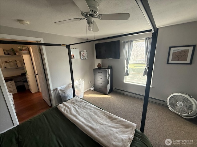 bedroom with a ceiling fan, a textured ceiling, and baseboard heating
