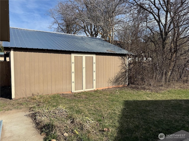 view of shed featuring fence