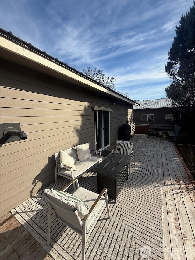 wooden terrace with grilling area and outdoor lounge area