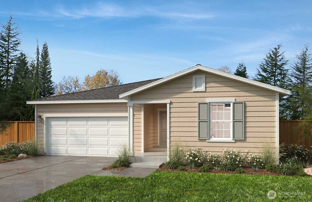 ranch-style home featuring a front yard, driveway, fence, and an attached garage